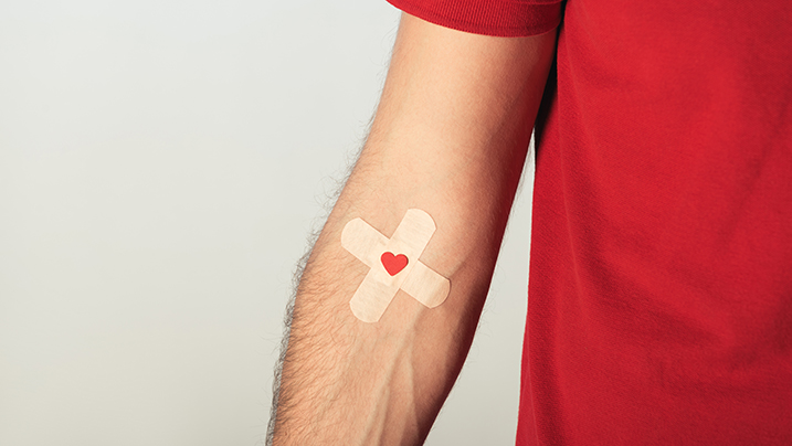 Partial,View,Of,Patient,In,Red,T-shirt,With,Plasters,On